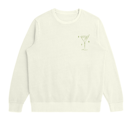White sweatshirt with a small graphic of martini glass and three olives on a white background