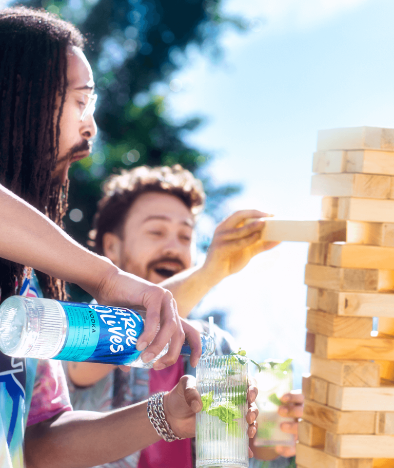 Three olives original being poured into cocktail glass